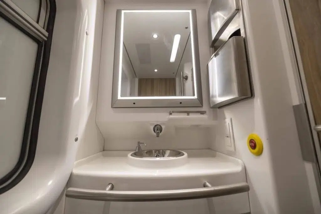 Washroom with sink and mirror outside the cabin on the sleeper train